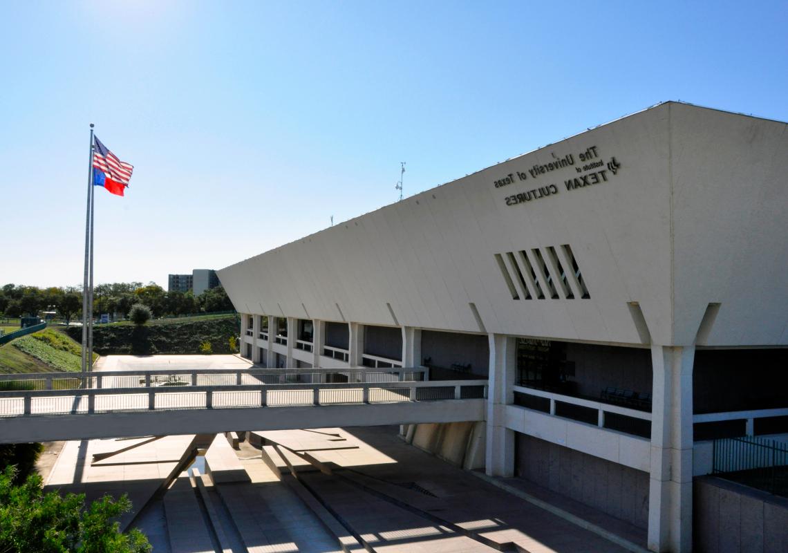 Hemisfair campus building with flags dancing in the wind